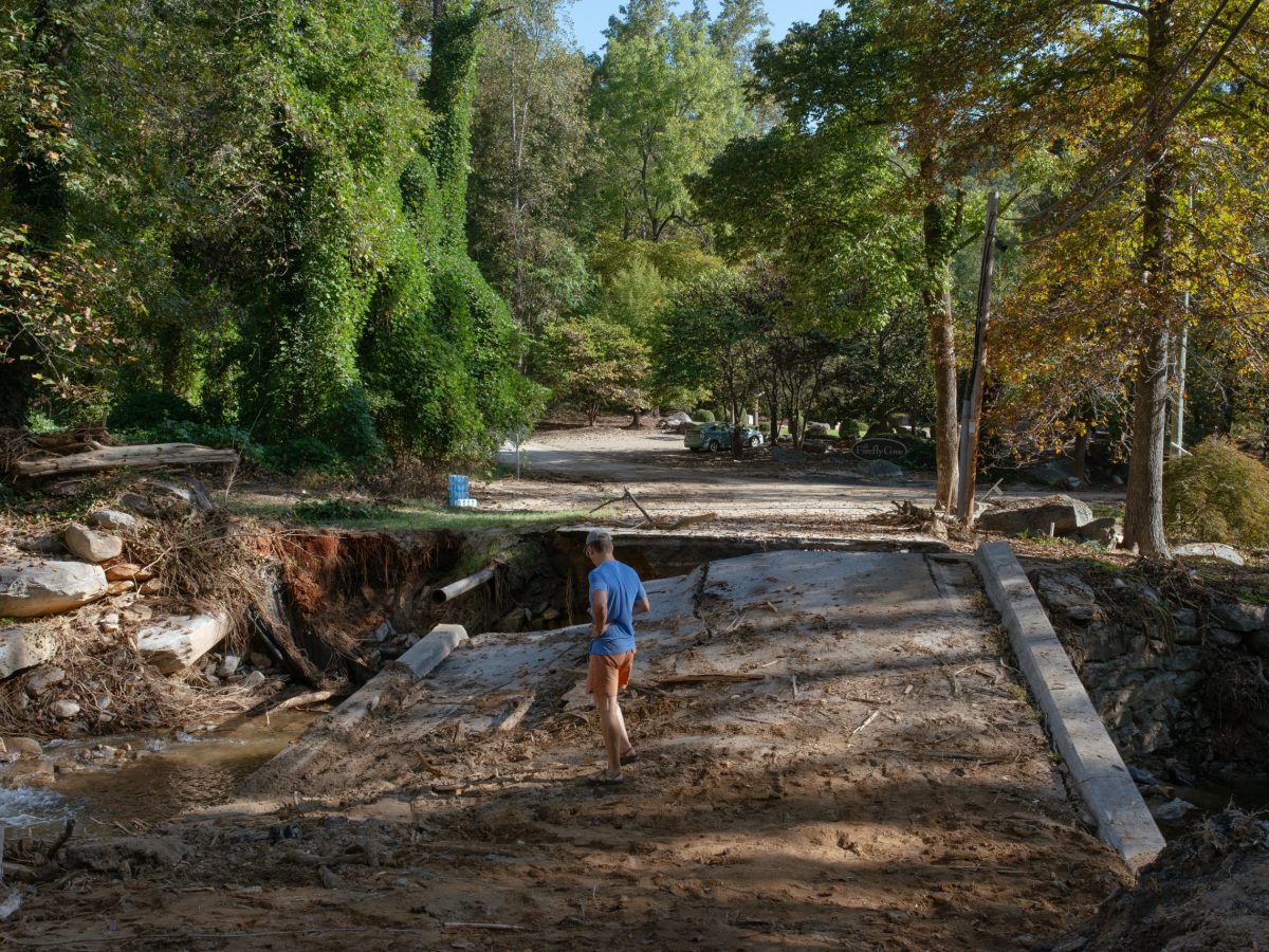 Man looking at cracked road