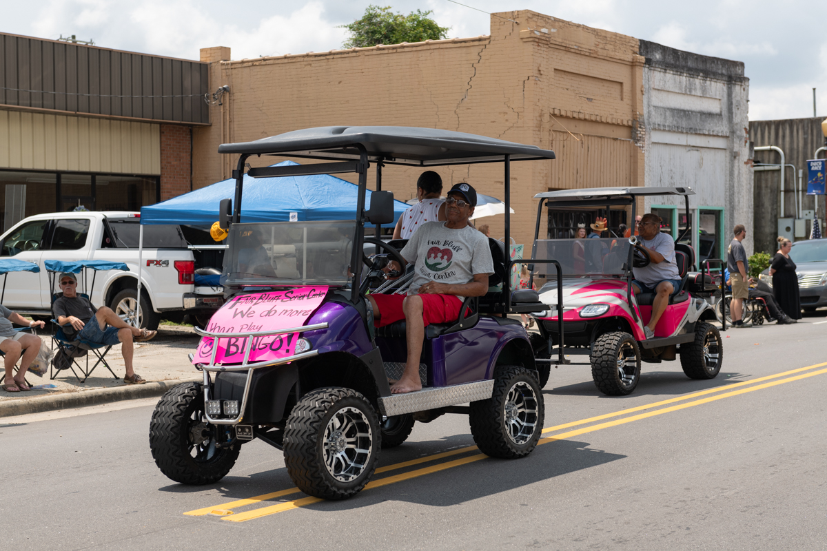 Red Evans in a purple golf cart