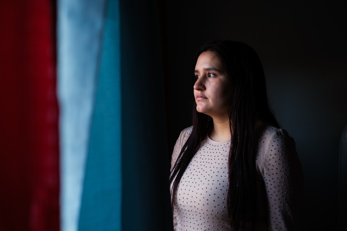 A woman stares out a window