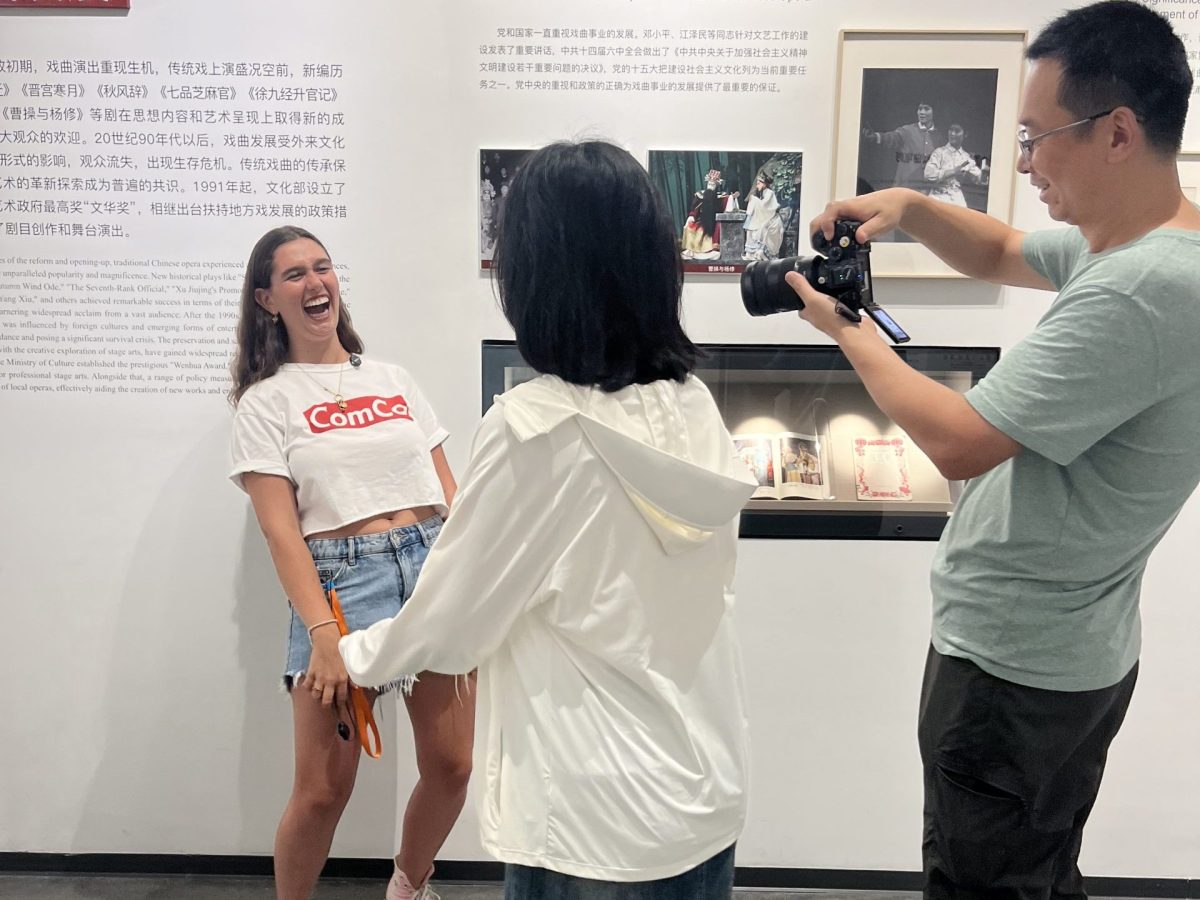 a woman laughs in a museum