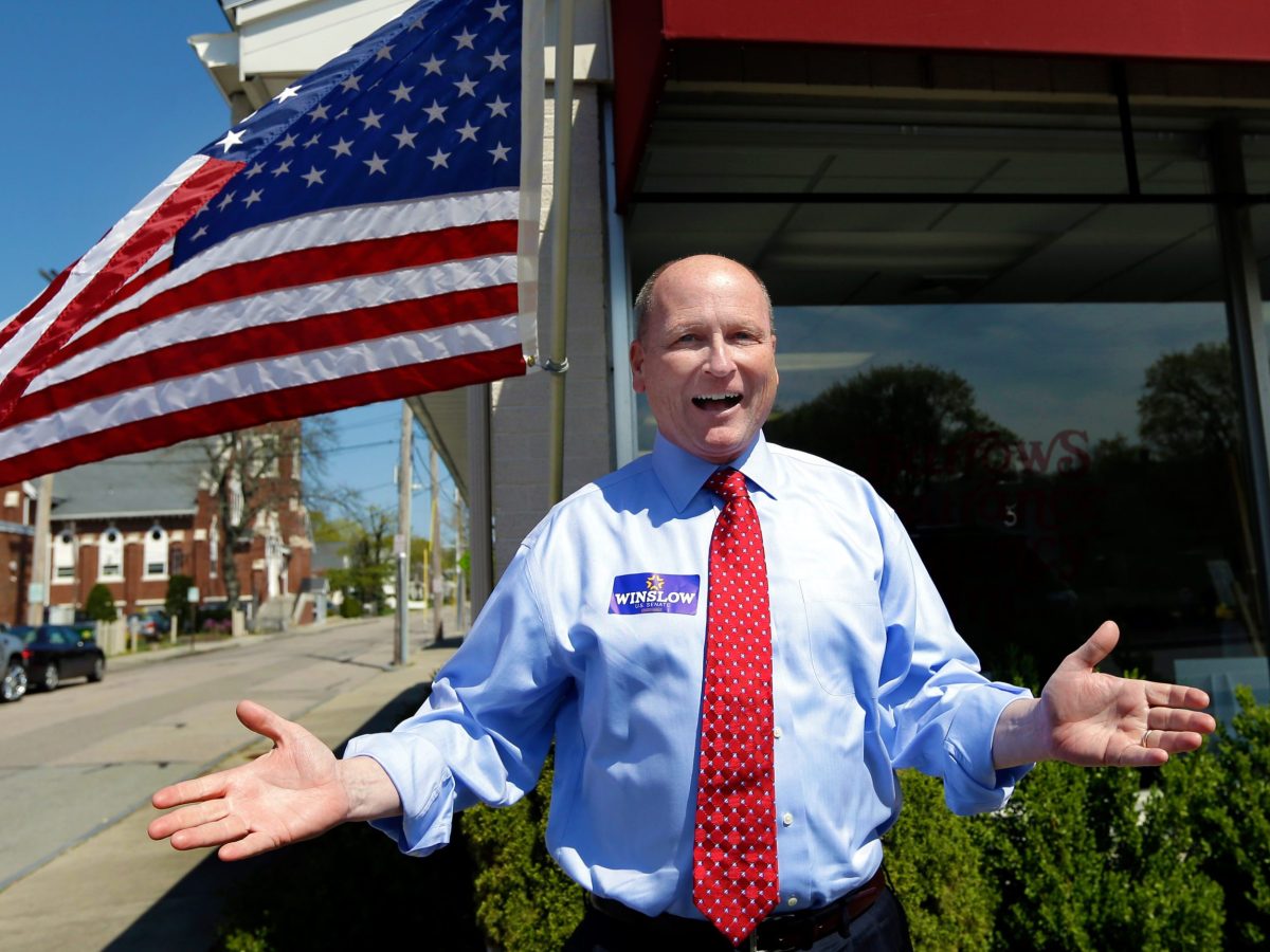 Dan Winslow in front of an american flag
